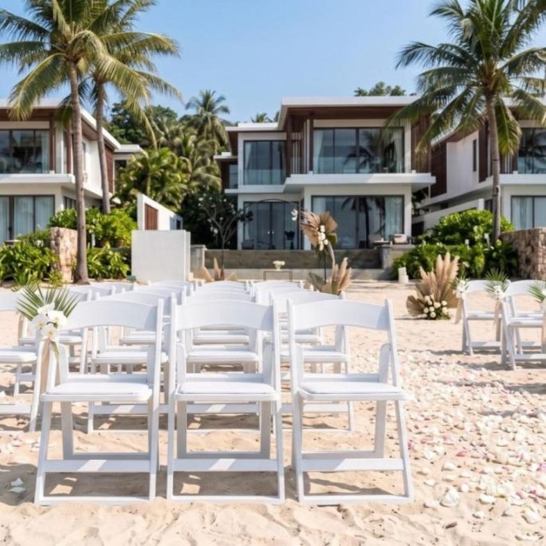 White seating at a beachfront ceremony